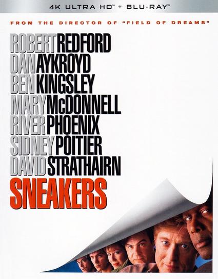 Image of the front cover of a UHD BD of the movie "Sneakers".

Against a metalic grey strip at the top is the text, "4K ULTRA HD™ + BLU-RAY™". On a plain white background is a note in red text about the unnamed director (Phil Alden Robinson), below which in grey and black bold text are the names of the main cast and in bigger bolder red text the title:

From the director of "Field of Dreams"

Robert Redford
Dan Aykroyd
Ben Kingsley
Mary McDonnell
River Phoenix
Sidney Poitier
David Strathairn

SNEAKERS

The bottom right shows the white background peeled up like a sheet behind which are the faces of six of the cast against a blue background looking at us.
