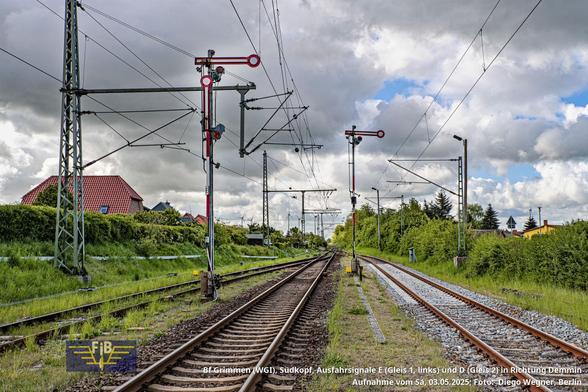 Blick auf die Ausfahrsignale E für Gleis 1 (links) und D für das durchgehende Hauptgleis 2 (Mitte). Rechts verläuft das Gleis 5 (dessen Ausfahrsignal steht im Rücken des Fotografen vor dem Bahnübergang Dr.-Kurt-Fischer-Straße). Diese Aufnahme entstand am 03.05.2025, mit dem BÜ im Rücken des Fotografen. Die Strecke 6088 ist im Abschnitt Stralsund – Neustrelitz eingleisig. Hinter dem Weichengebiet (zuerst folgt Weiche 2, dahinter Weiche 1) verläuft das Streckengleis weiter nach Demmin.