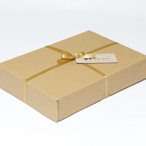 Picture shows a closed A4 box tied with gold ribbon.