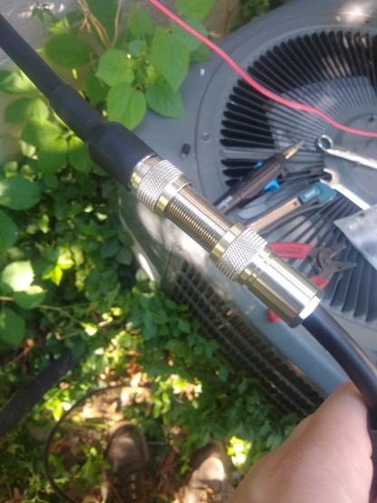 PL-259 connectors have been added to the ends of the cable, and they have been connected by a n SO-239 bulkhead connector.
