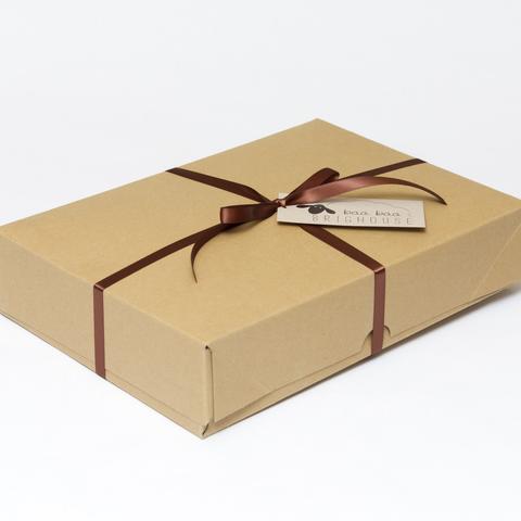 Picture shows a closed A4 box tied with brown ribbon.