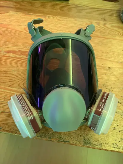 A full face visor mask with a tainted glass foil