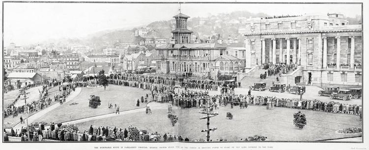 Black-and-white photo: The Memorable Scene in Parliament Grounds: Hushed Crowds Stand As the Coffin is Brought Forth to Start on the Long Journey to the Tomb. 1925. Description: New Zealand mourns her departed Prime Minister: The first scene in the touching tribute of sorrow at the funeral of the late Right Honourable W. F. Massey. The coffin is borne down the steps of Parliament building to the waiting motorised hearse. Citation: Supplement to the Auckland Weekly News, 21 May 1925, p. 47. Auckland Libraries Heritage Collections AWNS-19250521-47-02. https://kura.aucklandlibraries.govt.nz/digital/collection/photos/id/243939