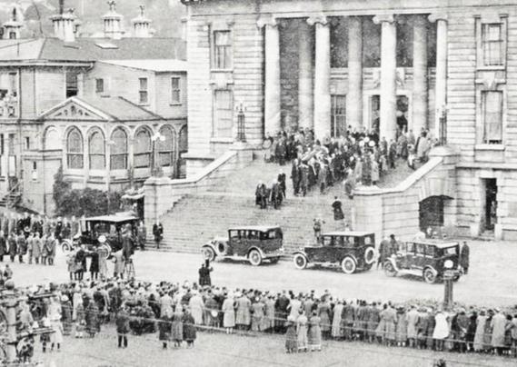Black-and-white photo: A detail from the previous photo, focusing on the funeral party.