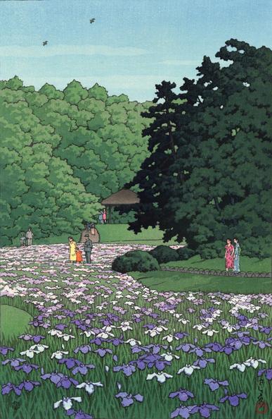 A view of a grassy field at Meiji Jingu, full of pale blue and lavender irises in bloom. The field is hemmed in by tall trees on either side; visitors walk along a curving path, admiring the flowers. Above, a pair of birds wheel in a bright blue sky.