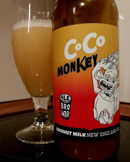 A bottle and a glass of coconut milk NEIPA beer made by Ale Browar.