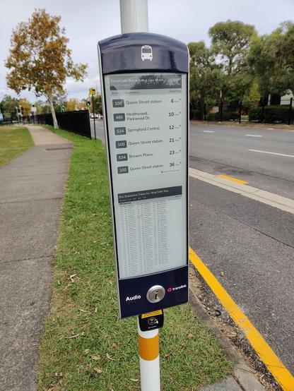 A bus stop timetable sign that looks like it is printed but is actually live data updating each minute