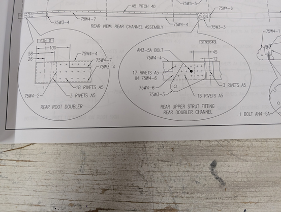 Technical drawing detailing the rivets, holes, parts, and spacing for rear spar reinforcement on the wing.