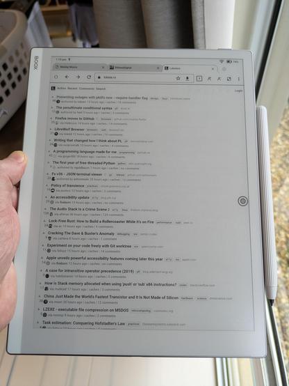 Photo of me holding Onyx Boox Go 10.3. On-screen is the Lobsters webiste.