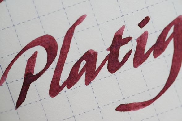 Word "Platig(num)" in red-brown mahogany-tone ink