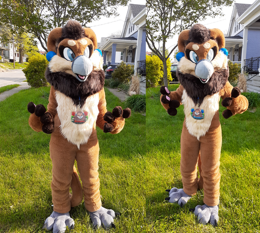 Two photographs of a brown gryphon fursuiter, wearing an acrylic charm badge with artwork depicting the character. The photo on the left shows one side of the badge with red flowers and the character's eyes closed, and the photo of the right shows the other side of the badge with blue flowers and the character's eyes open. The badge is very large, measuring 6 in. (15.24 cm) and sits at the fursuiter's midsection. The suit is made by That's Furred Up.
