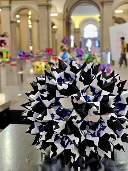 Black and white origami figure in an exhibition hall