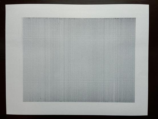 A faint, grainy gray rectangle drawn on a piece of paper