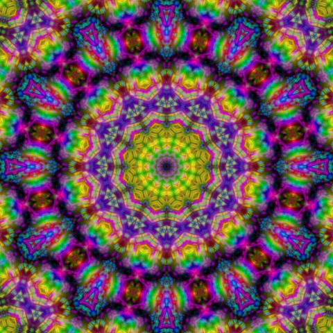 Mandala made of rainbow crystals with rings of yellow and purple around the center
