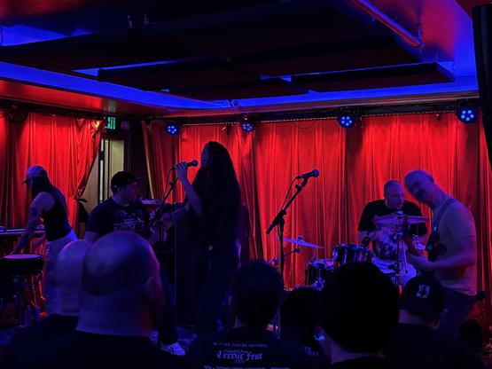 Red curtains, purple light, five piece band BRINGING IT.