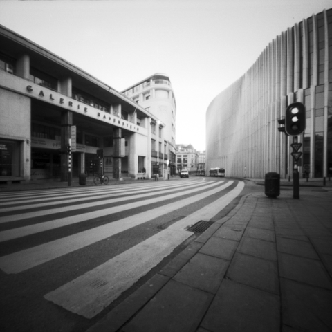 Photograph looking down the street at a crosswalk in front of Galerie Ravenstein in Brussels