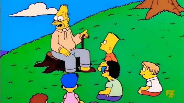 Meme de Abe Simson contando batallitas a un grupo de niños en un prado. El abuelo está sentado sobre un tocón y varios niños le escuchan sentados sobre la hierba. A la derecha hay un árbol. Al fondo el cielo azul con una pequeña nube.
