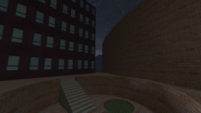 View of a sunken circular garden with circular patches of grass. This screenshot is from outside the encircling structure and features a different building which is shorter.