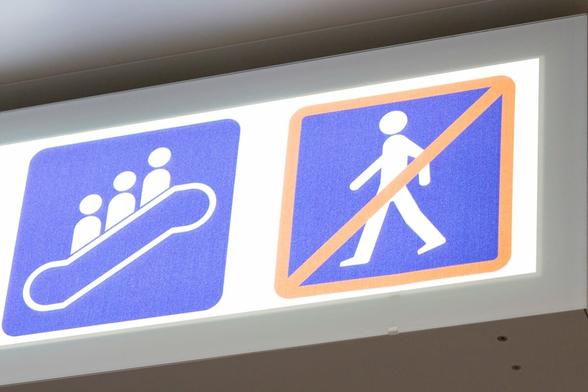 Sign showing standing on the escalator and prohibiting walking