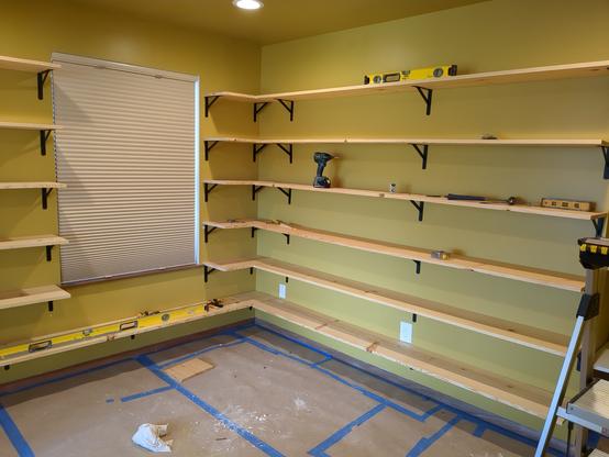 The next run of shelving wraps the corner and fills the next wall.