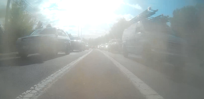 same van in traffic on Barbur approaching Terwilliger, where the bike lane is between a freeway offramp/slip lane and thru traffic, because cars are fast