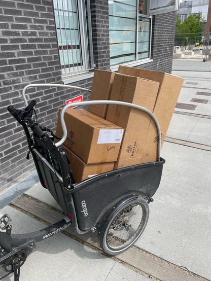 Cargo bike loaded with boxes of furniture.