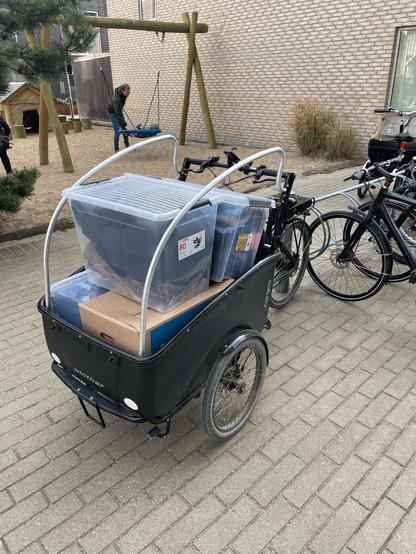 Cargo bike loaded with various containers.