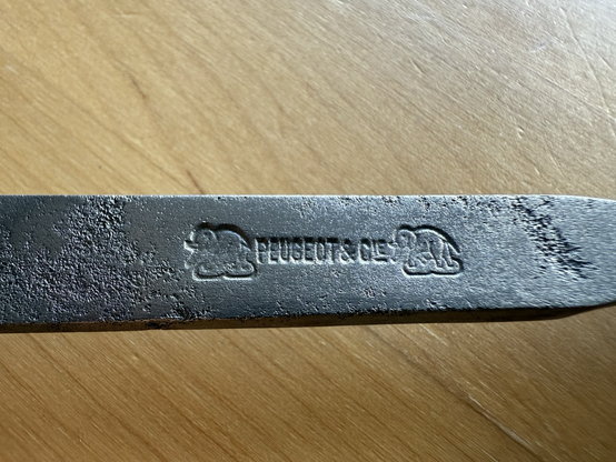 Close-up on the brand: Peugeot & Cie, with an elephant engraving on either side
