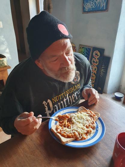 Mike Meyer sign painter enjoying a plate of beans on toast