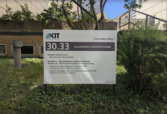 The Institute of Biomedical Enguneering is located on KIT campus in building 30.33 (Allgemeine Elektrotechnik). The photo shows the information sign for building 30.33 in front of the building with a lot of greens around.