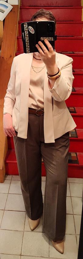 Beige satin shell, taupe trousers, off-white floppy blazer. Mocha belt, beige slingbacks. The jewelry is the star: brown and white mermaid pearl necklaces, brown and mocha wooden bracelets.