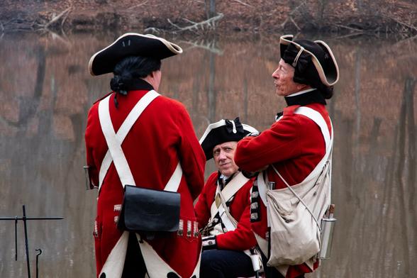 Three British 'Red Coats' preparing for a reenacting of the Battle Of Guilford Courthouse on the anniversary of the event in the American Revolution.