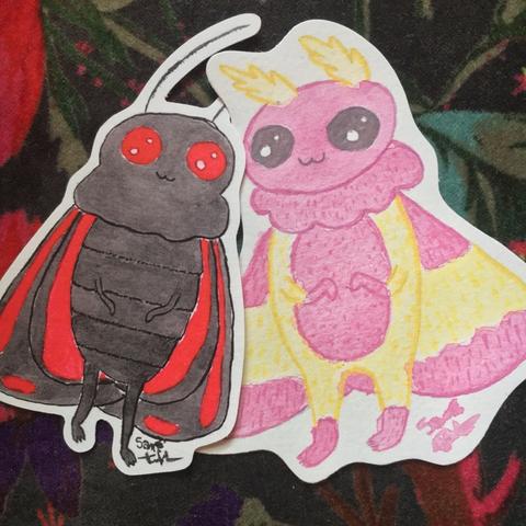 Two stickers of a cinnabar mothman and a rosy maple mothman who are in love