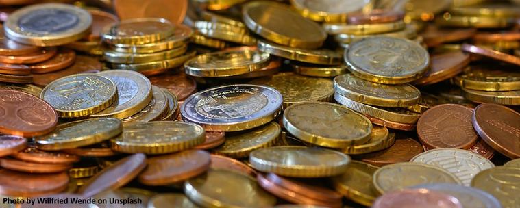 An image of coins representing an individuals assets held within a defined contribution pension plan.