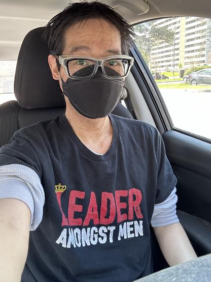 Me wearing a black CAN99 mask and eye protection. My shirt says “Leader Amongst Men”.
