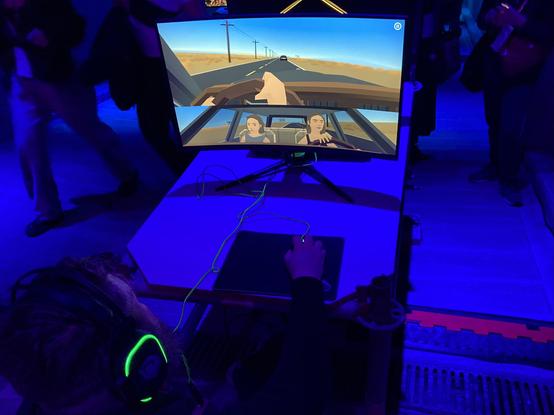 a photo showing a screen on which runs a demo of Crossing Lines, a driving simulation game