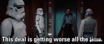 Lando Calrissian walks into a room with Lobot and two stormtroopers. Lando says, “This deal is getting worse all the time.”