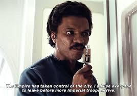 Lando Calrissian speaks into an intercom to broadcast a message to everyone in Cloud City, “The Empire has taken control of the city. I advise everyone to leave before more Imperial troops arrive.”