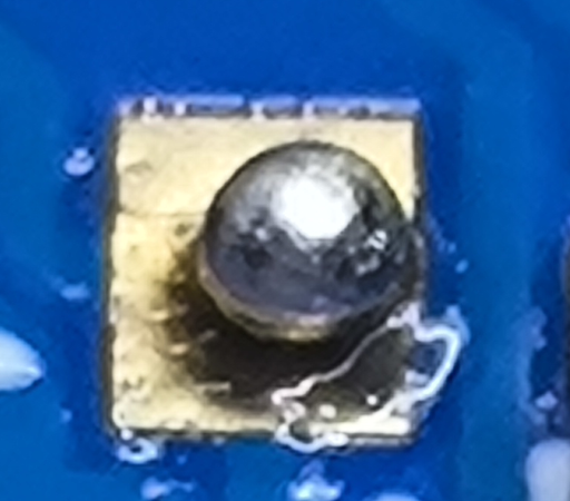 Close up of the pad that didn't have a component fitted, the solder paste has balled up on the pad surrounded by flux.