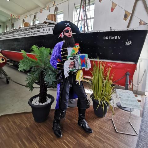 some weirdo in a costume of patchy the pirate pretending to play the accordeon and his parrot is judging lol