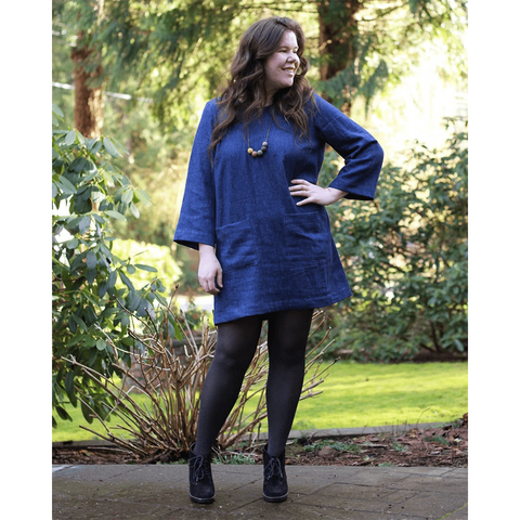 Helen wears a shift dress with patch pockets and bracelet-length sleeves.