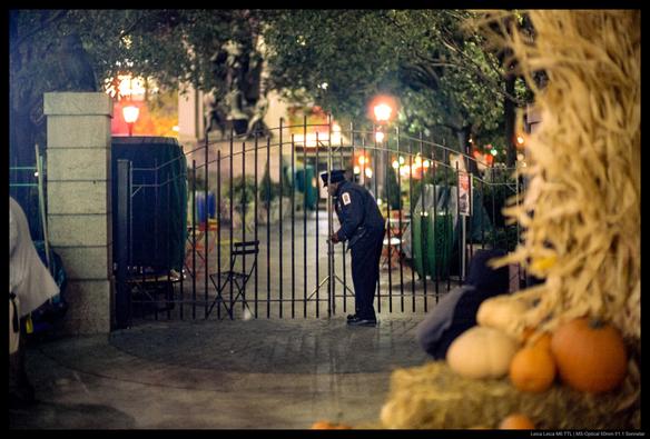 A police officer closes the gates to a small NYC park.