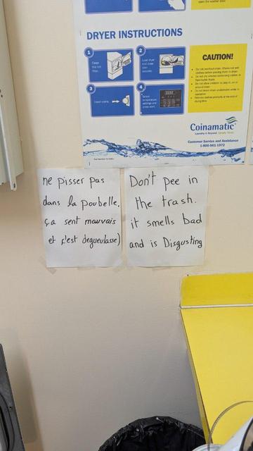 Two handwritten notes above a trash can, one in French, one in English.

They both read: don't pee in the trash. It smells bad and is disgusting