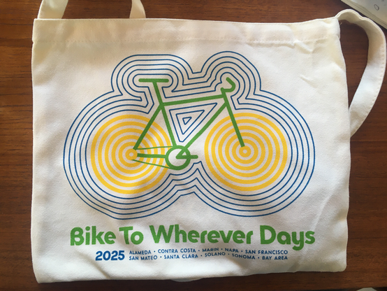 Bike to wherever days 2025 canvas tote bag with bike with concentric circles for wheels and concentric outlines around the bike