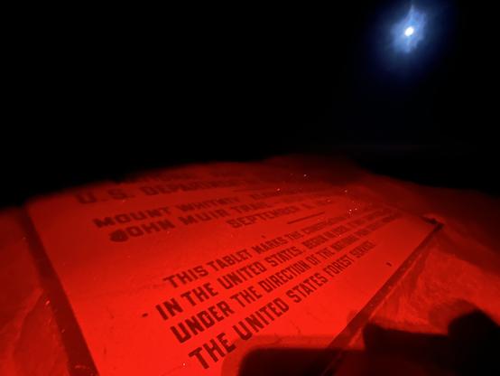Summit plaque on Mount Whitney at night