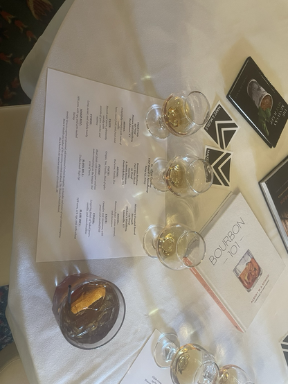 El Jefe’s sampler glasses of 3 fine bourbons, plus an old fashioned, on a table with a white cloth.