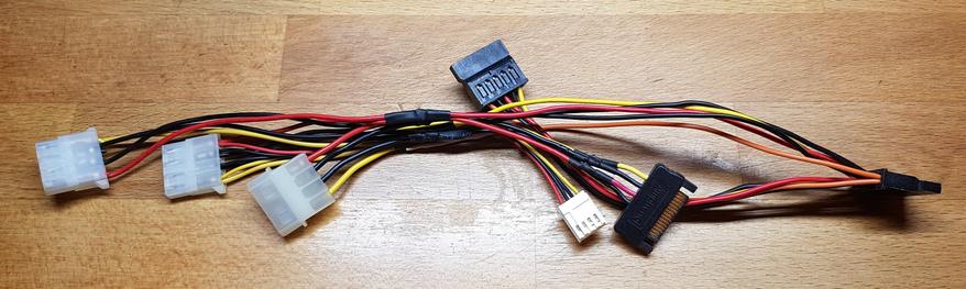 My DIY "Franken-daptor"; it adapts the 5V & 12V lines across Molex/SATA/Berg (the orange SATA 3.3V line is not connected, though)