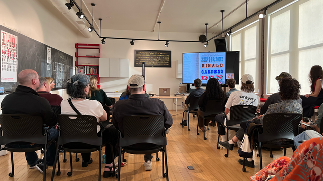 An audience viewing some of Letterform Archive's collection