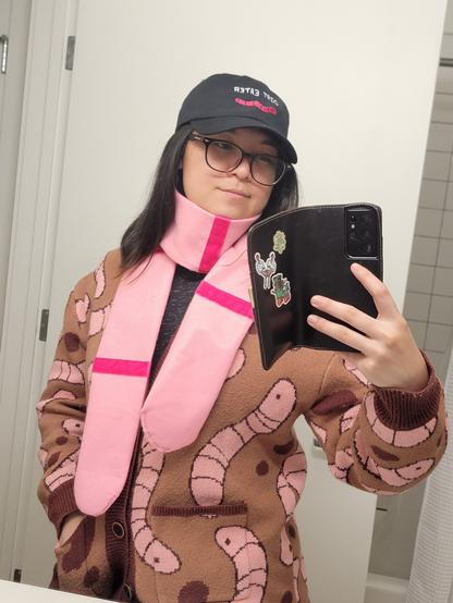 It's a selfie of myself wearing a worm hat, that says dirt eater, a worm scarf, and a worm cardigan