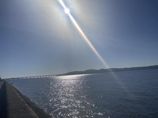 View across Tay Firth the sun high and bright in a clear sky glistening on the water